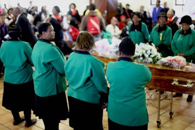 ANC women surrounding the coffin inside Church Hall