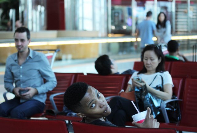 Sept. 18, 2013 in Dubai Intl Airport waiting for our connecting flight to LA. Sipping fresh mixed berries juice... © Zanele Muholi