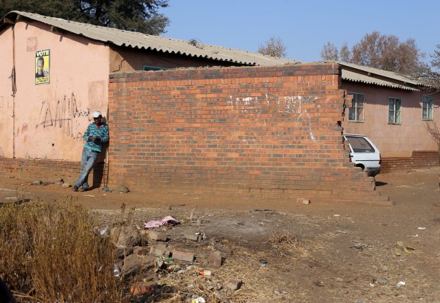 a man standing outside merafe hostel by thando methane_1063
